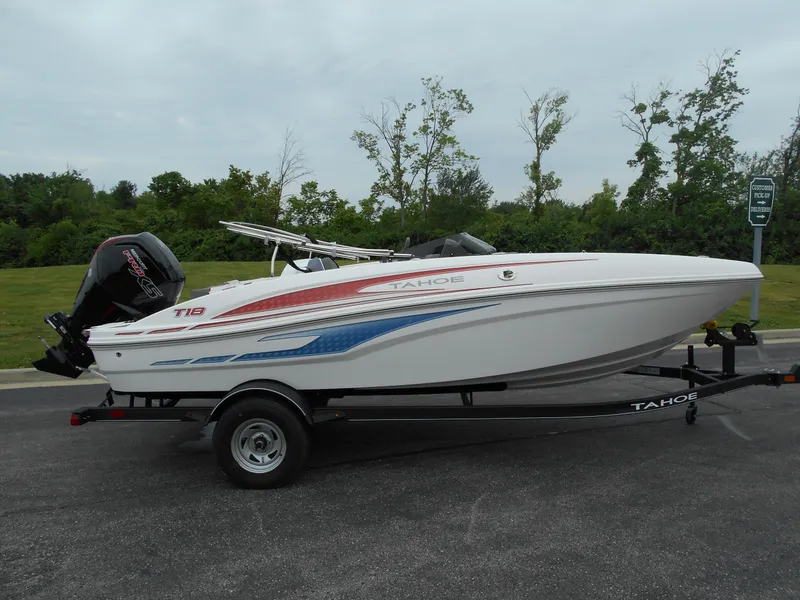 Slide: The Image of 2024 Tahoe T18 boat on trailer, side view, white with red and blue accents. - 0