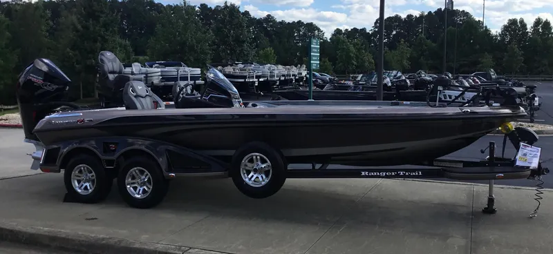 The Image of 2024 Ranger Z521R bass boat on a trailer in a dealership lot. - 0
