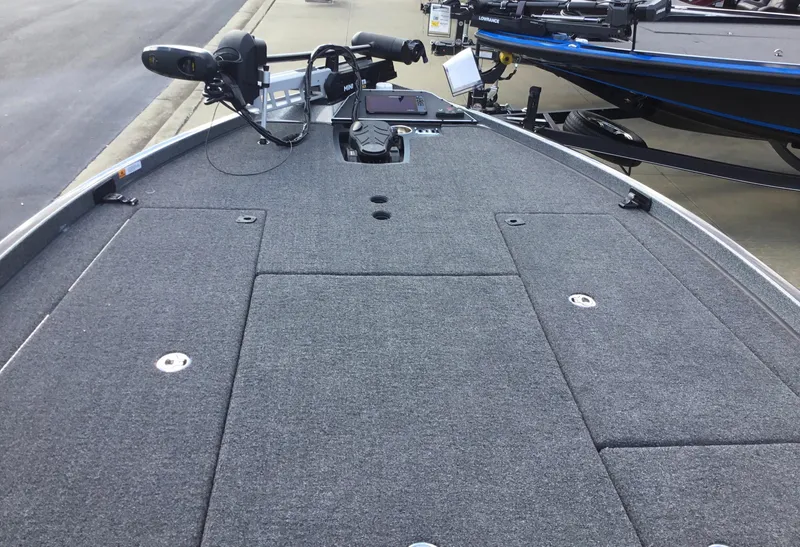 Slide: The Image of 2024 Ranger Z521R fishing boat deck with trolling motor and storage compartments. - 2