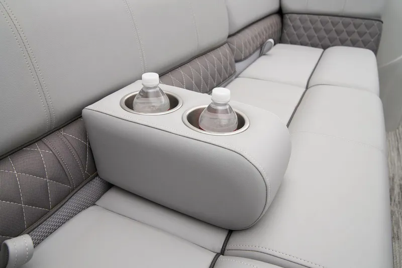 Slide: The Image of 2024 Ranger Reata 223FC boat interior with cup holders and cushioned seating. - 19