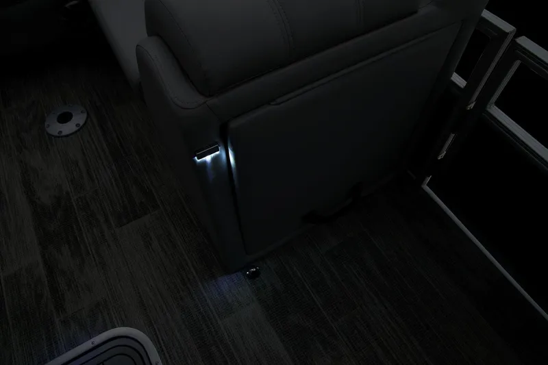 Slide: The Image of 2024 Ranger Reata 223FC interior with ambient lighting and dark wood flooring. - 30