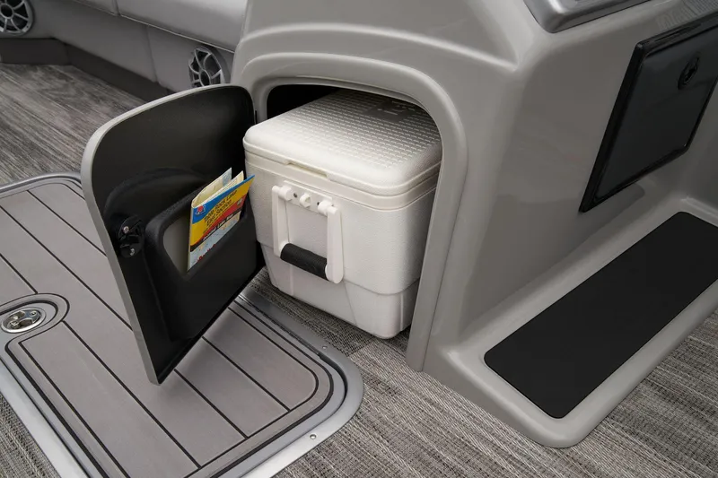 Slide: The Image of 2024 Ranger Reata 223FC storage compartment with cooler and magazine holder. - 38