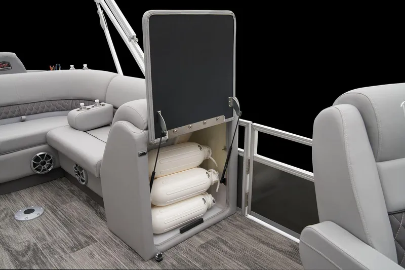 Slide: The Image of 2024 Ranger Reata 223FC boat interior storage compartment with life jackets. - 42