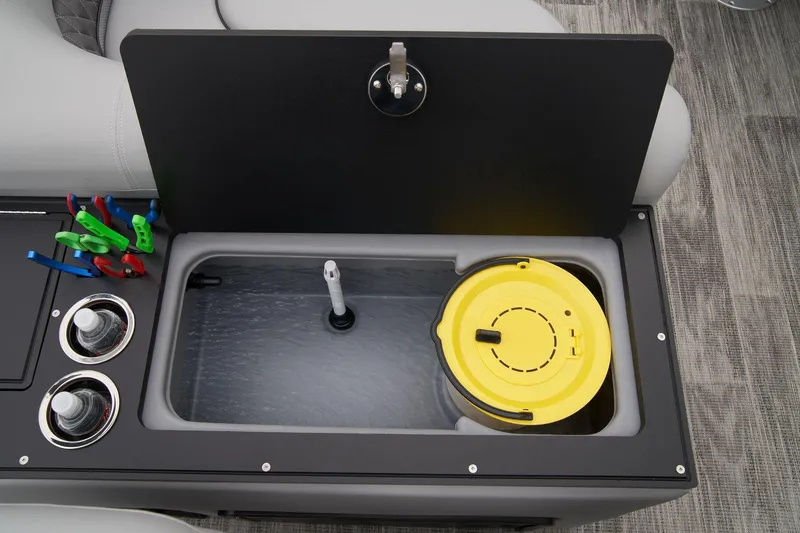 Slide: The Image of 2024 Ranger Reata 223FC boat storage compartment with cup holders and fishing accessories. - 46