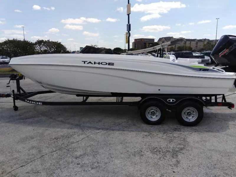 Slide: The Image of 2024 Tahoe T21 boat on trailer in parking lot. - 1