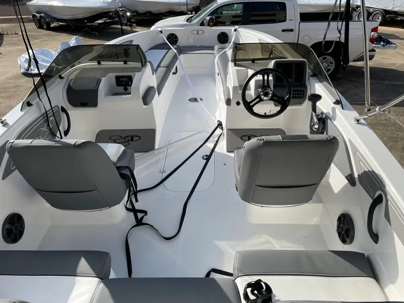 Slide: The Image of 2024 Tahoe T21 boat interior with dual consoles and gray seating. - 7