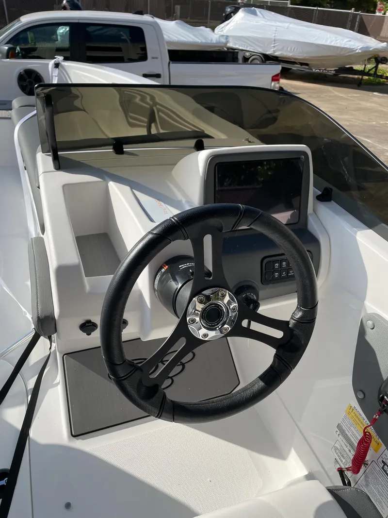 Slide: The Image of 2024 Tahoe T21 boat dashboard with steering wheel and control panel. - 8