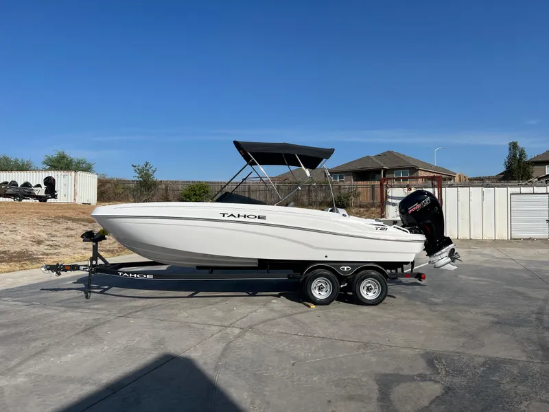 The Image of 2024 Tahoe T21 boat on trailer in driveway, ready for transport. - 0