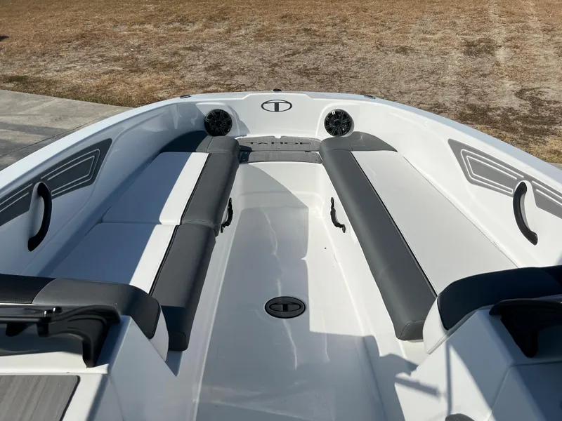 Slide: The Image of 2024 Tahoe T21 boat interior with cushioned seating and built-in speakers. - 4