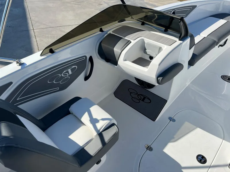 Slide: The Image of 2024 Tahoe T21 boat interior with seating and steering console. - 6