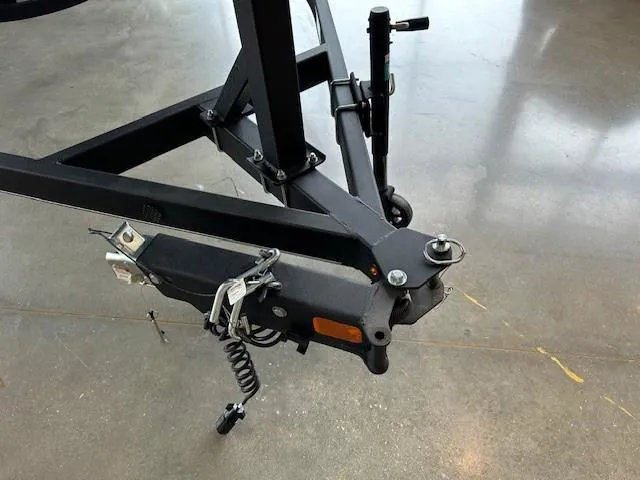 Slide: The Image of 2024 Tahoe T21 trailer hitch and coupler assembly on concrete floor. - 2