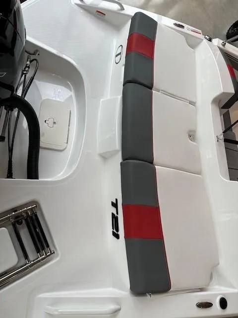 Slide: The Image of 2024 Tahoe T21 boat with red and gray cushioned seating. - 3