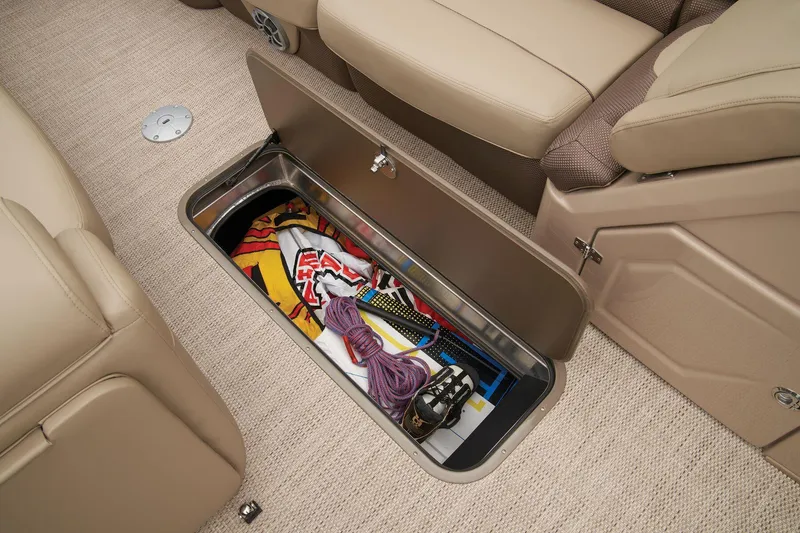 Slide: The Image of 2024 Regency 250 DL3 under-seat storage compartment with various items. - 22