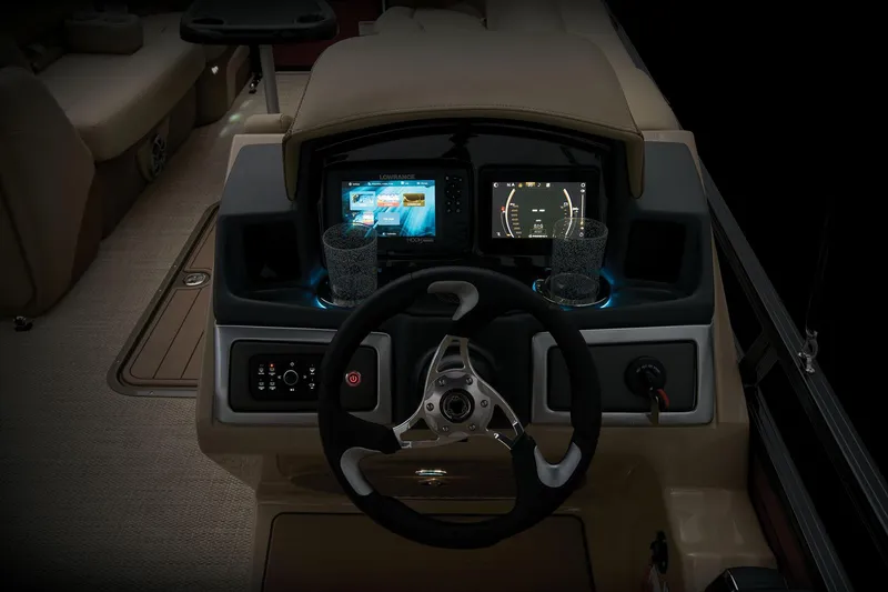 Slide: The Image of 2024 Regency 250 DL3 boat dashboard with dual displays and illuminated cup holders. - 49