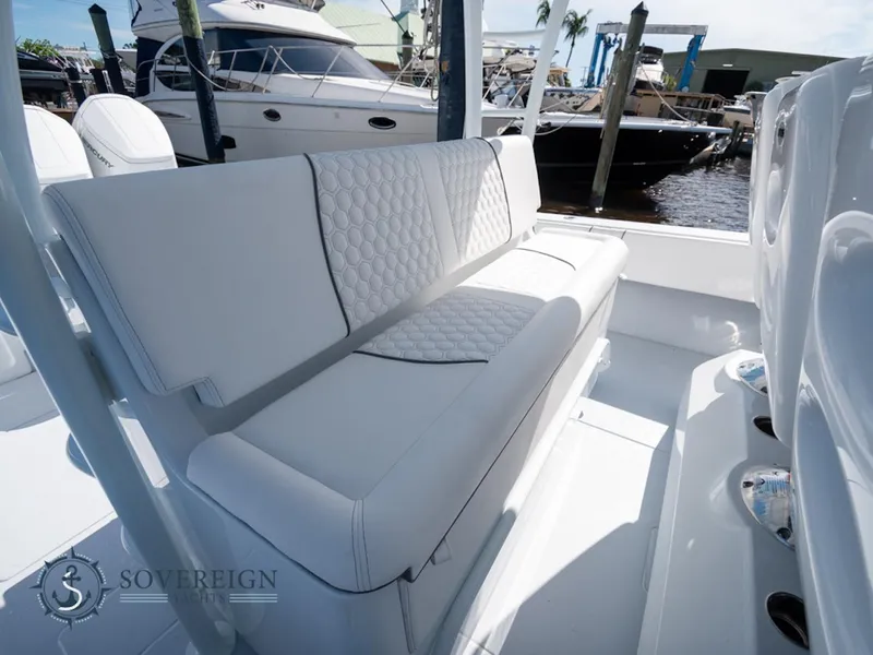 Slide: The Image of 2024 Contender 44 CB boat with luxurious white seating at a marina. - 13