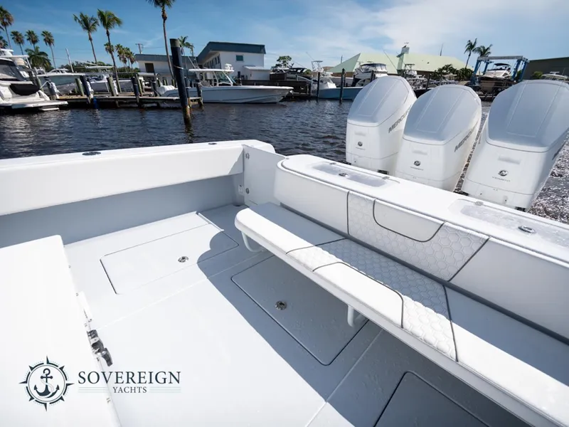 Slide: The Image of 2024 Contender 44 CB boat with triple outboard engines at a marina. - 19