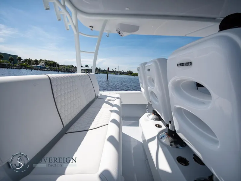 Slide: The Image of 2024 Contender 44 CB boat interior with white seating, Sovereign Yachts logo, and waterfront view. - 22