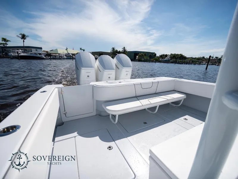 Slide: The Image of 2024 Contender 44 CB boat with triple outboard engines on a sunny day. - 23