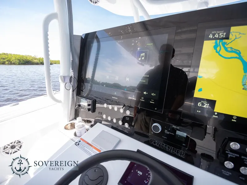 Slide: The Image of 2024 Contender 44 CB yacht dashboard with navigation and control systems, Sovereign Yachts logo. - 25
