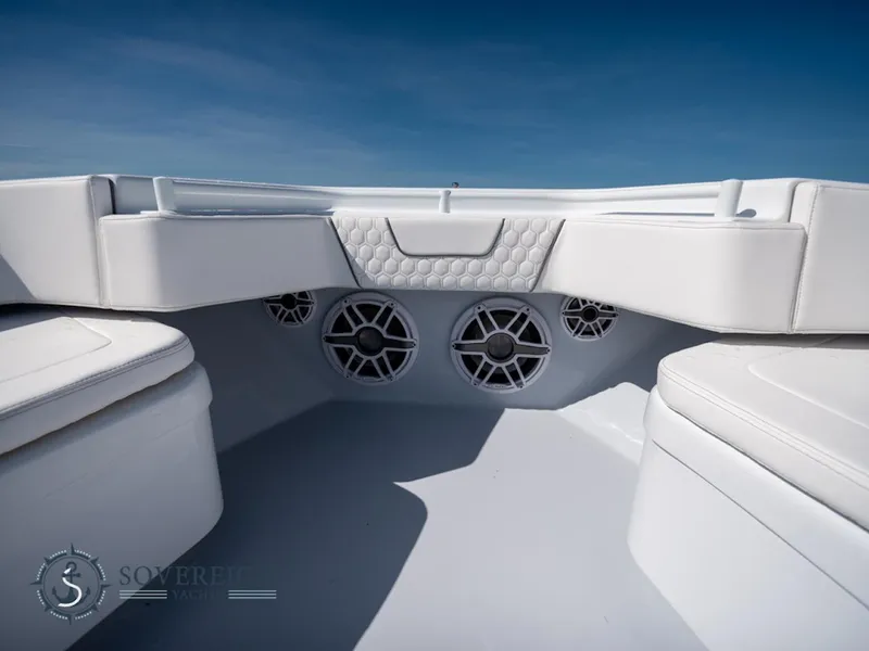 Slide: The Image of Contender 44 CB 2024 boat interior with white seating and built-in speakers. - 29