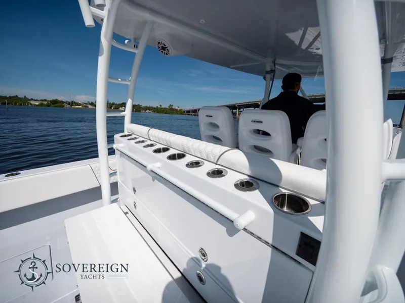 Slide: The Image of 2024 Contender 44 CB yacht interior with rod holders and seating, Sovereign Yachts logo. - 35
