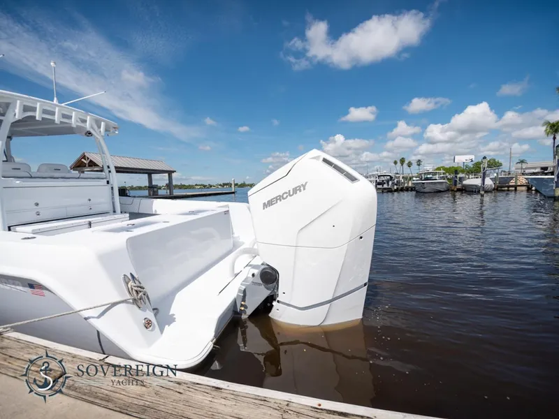 Slide: The Image of 2024 Contender 44 CB boat with Mercury outboard engine docked at marina. - 37