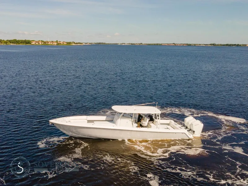 Slide: The Image of 2024 Contender 44 CB boat cruising on a calm lake. - 6