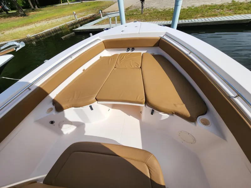 Slide: The Image of 2008 Grady-White 306 Bimini CC boat with tan cushions docked at marina. - 12