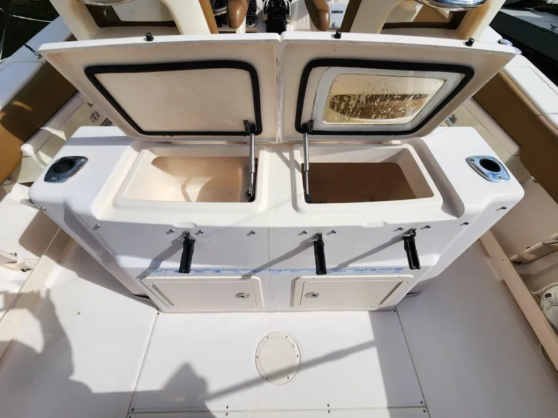 Slide: The Image of 2008 Grady-White 306 Bimini CC center console storage compartments open. - 5