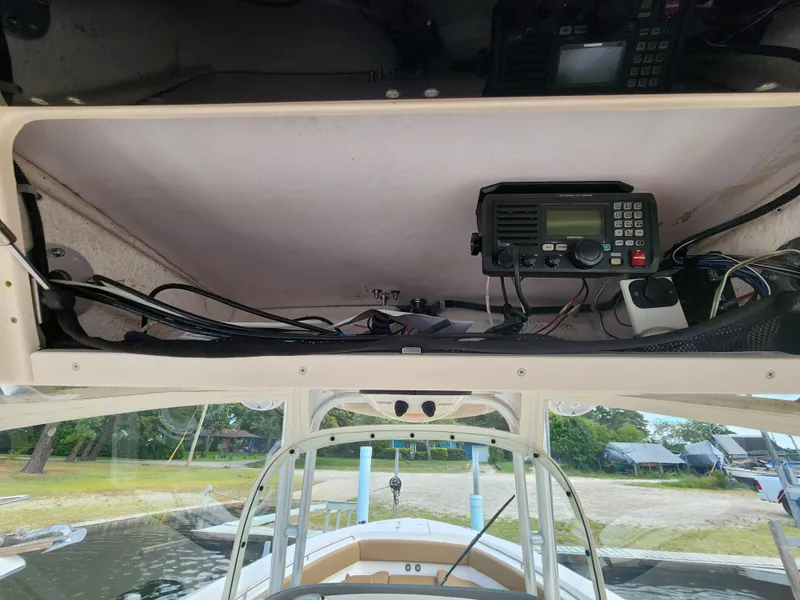 Slide: The Image of 2008 Grady-White 306 Bimini CC boat electronics compartment with radio equipment. - 9