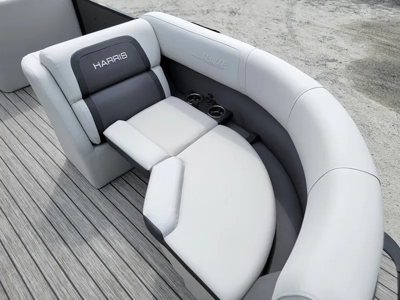 Slide: The Image of 2024 Harris Cruiser 210 boat interior with cushioned seating and cup holders. - 10