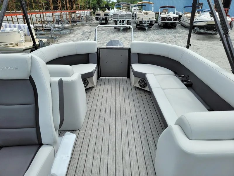 Slide: The Image of 2024 Harris Cruiser 210 pontoon boat interior with gray seating and wood-like flooring. - 12