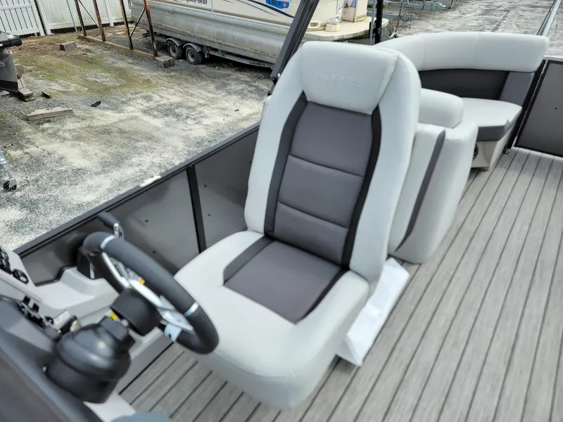 Slide: The Image of 2024 Harris Cruiser 210 boat interior with captain's chair and seating. - 14