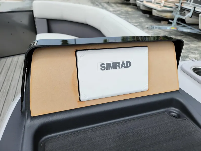 Slide: The Image of 2024 Harris Cruiser 210 boat dashboard with Simrad navigation system. - 16