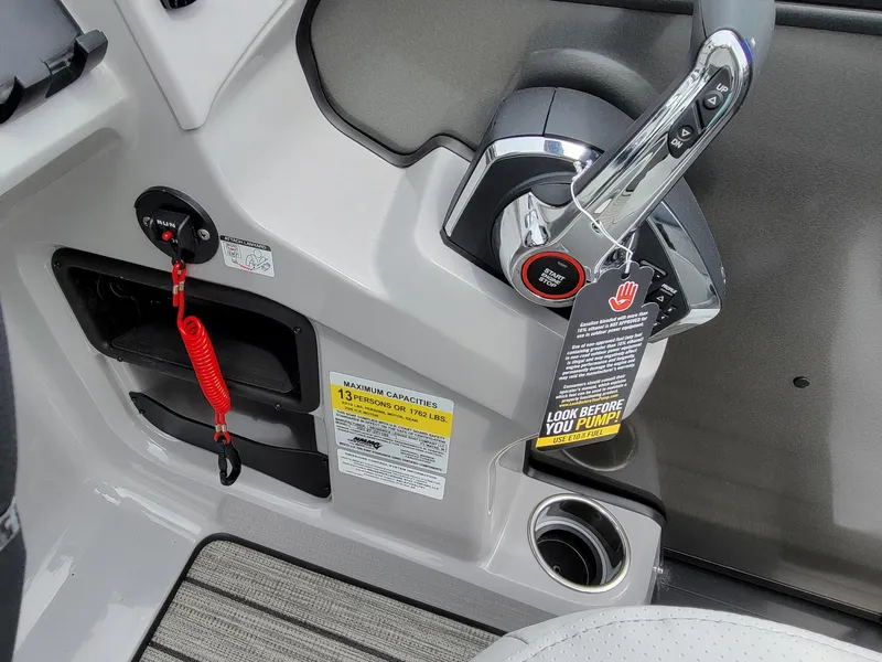 Slide: The Image of 2024 Harris Cruiser 210 boat control panel with safety features and ignition switch. - 18