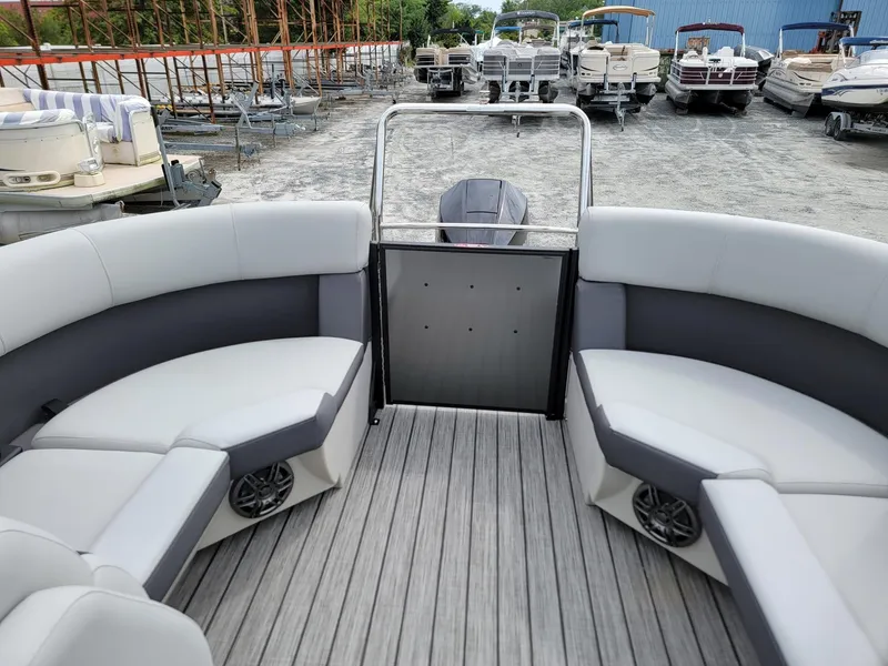 Slide: The Image of 2024 Harris Cruiser 210 pontoon boat interior with gray seating and flooring. - 19