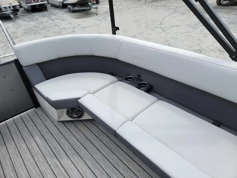 Slide: The Image of 2024 Harris Cruiser 210 boat interior with cushioned seating and cup holders. - 20