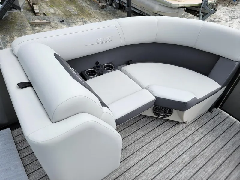 Slide: The Image of 2024 Harris Cruiser 210 boat interior with plush seating and cup holders. - 22