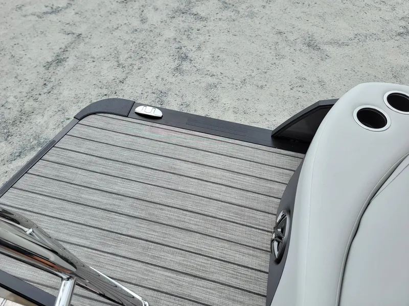Slide: The Image of 2024 Harris Cruiser 210 boat deck with cup holders and ladder. - 27