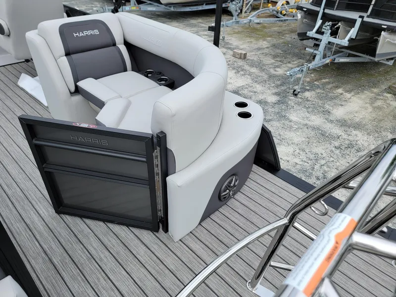 Slide: The Image of 2024 Harris Cruiser 210 boat interior with gray seating and cup holders. - 28