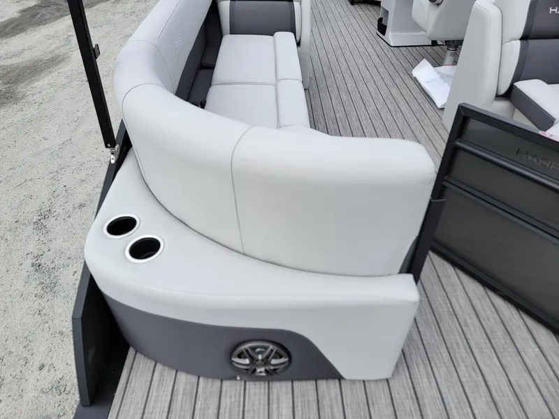Slide: The Image of 2024 Harris Cruiser 210 boat interior with cushioned seating and cup holders. - 29
