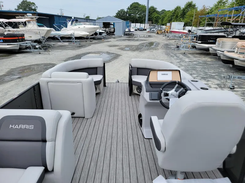 Slide: The Image of 2024 Harris Cruiser 210 pontoon boat interior at a marina. - 31