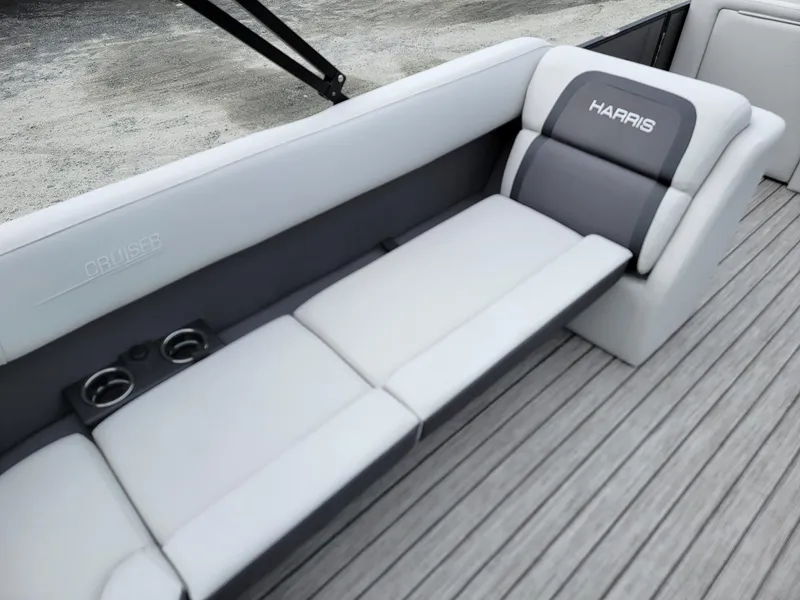 Slide: The Image of 2024 Harris Cruiser 210 boat interior with gray cushioned seating and cup holders. - 32