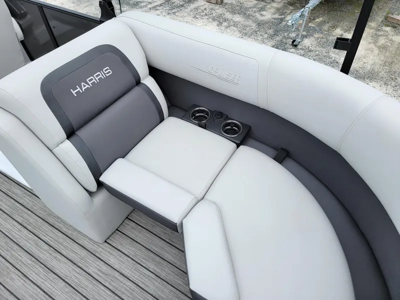 Slide: The Image of 2024 Harris Cruiser 210 boat interior with cushioned seating and cup holders. - 33