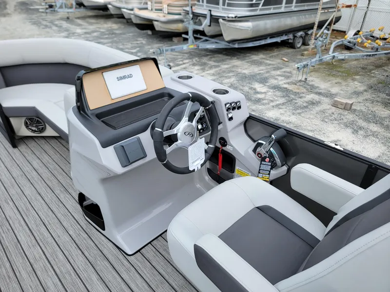 Slide: The Image of 2024 Harris Cruiser 210 boat interior with steering console and seating. - 34