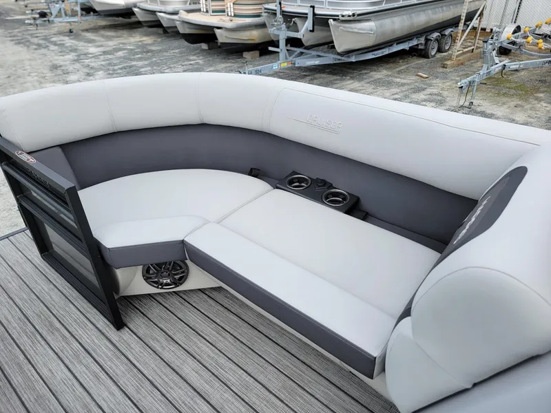 Slide: The Image of 2024 Harris Cruiser 210 boat interior with gray seating and cup holders. - 37