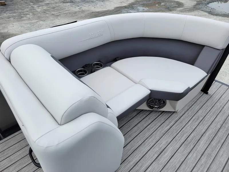 Slide: The Image of 2024 Harris Cruiser 210 boat interior seating with cup holders and speakers. - 38