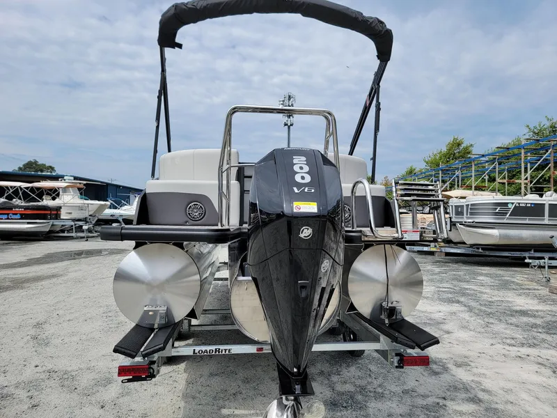 Slide: The Image of 2024 Harris Cruiser 210 boat with a 200 V6 engine on a trailer. - 4