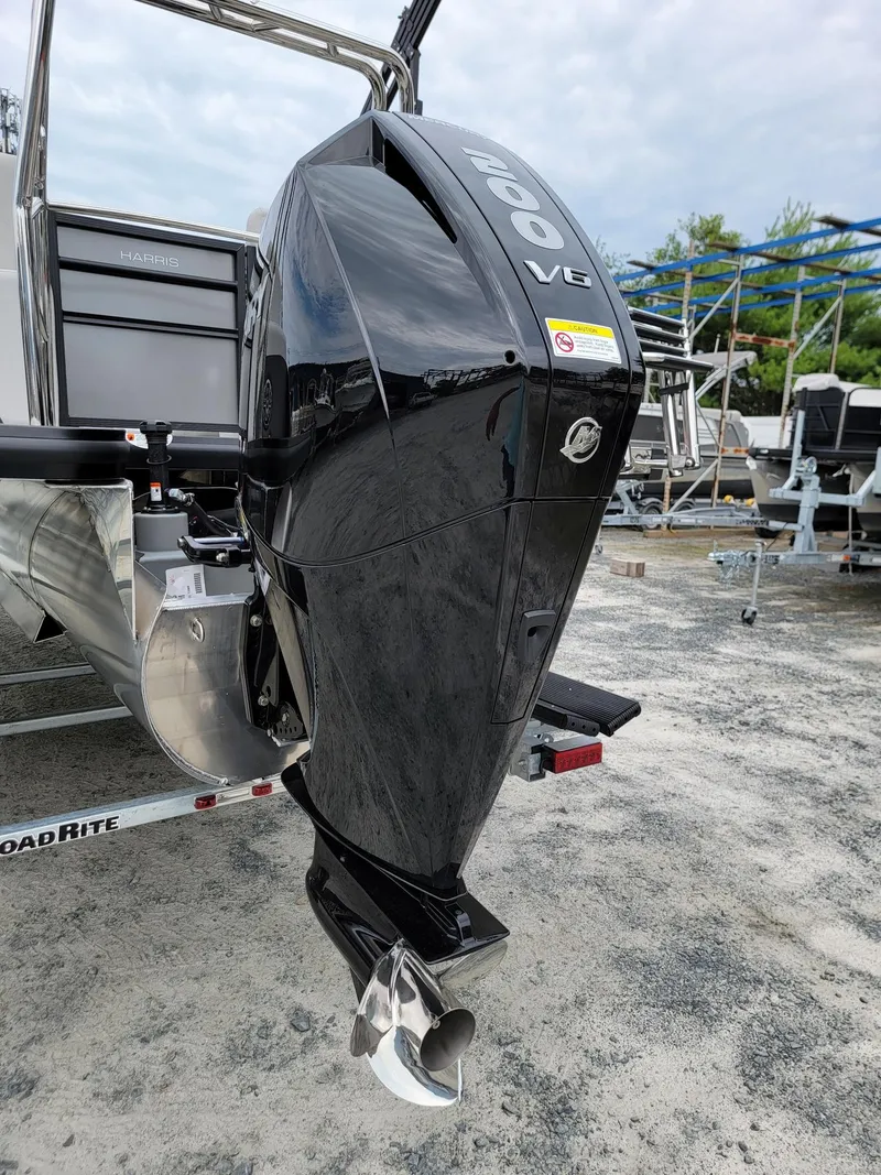 Slide: The Image of 2024 Harris Cruiser 210 with powerful outboard motor. - 42