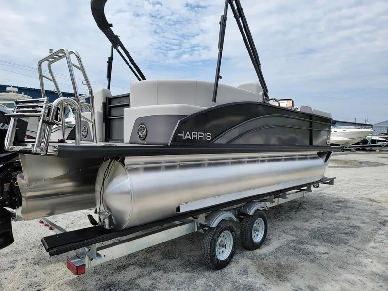 Slide: The Image of 2024 Harris Cruiser 210 pontoon boat on trailer, side view. - 5